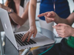 People looking at a laptop computer.